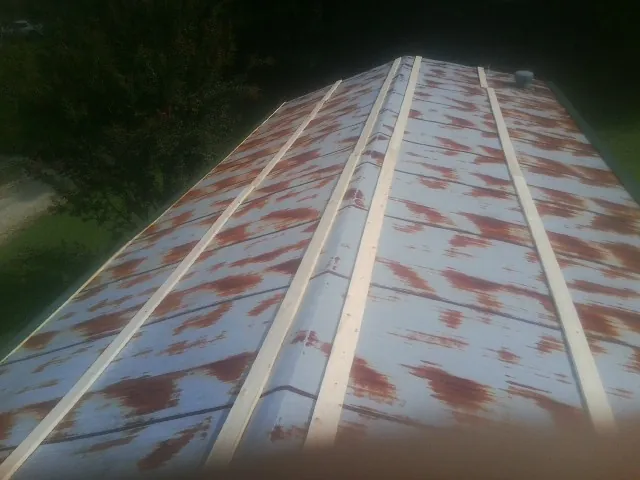 Rusted metal roof panels with new wood purlins before replacement — Storm Damage Roof Repair in Eagle Bridge by Roofing Brothers