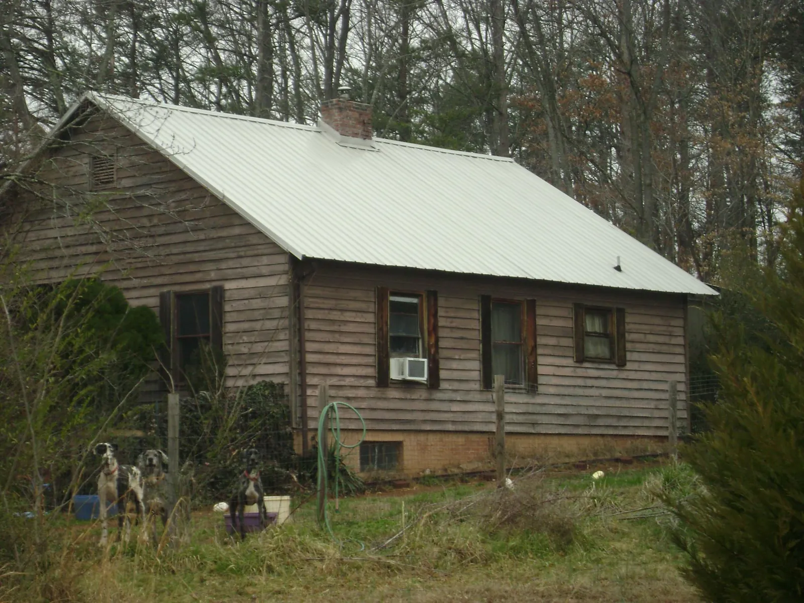 White metal roof on an old wood sided farmhouse, from a Metal Roof Installation job in Eagle Bridge